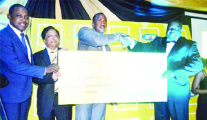 • SPORTS Minister, Chishimba Kambwili (right) presents a K25,000 dummy cheque to Red Arrows defender, Bronson Chama for winning the 2013 MTN Footballer of the Year award as MTN chief executive officer, Abdul Ismail and FAZ President Kalusha Bwalya (left) look on. The awards ceremony was held at Moba Hotel in Kitwe on Wednesday.  Picture by MOFFAT CHAZINGWA.