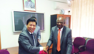 • Chinese Ambassador to Zambia Zhou Yuxiao (left) and Finance Minister Alexander Chikwanda, shake hands shortly after signing the Framework Agreement in Lusaka on Tuesday. Picture Courtesy of the Chinese Embassy.