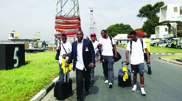• GOALKEEPING coach Davies Phiri and some players at Kenneth Kaunda International Airport in Lusaka yesterday shortly before leaving for Mozambique. Picture courtesy of FAZ