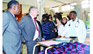 • Vice-President Guy Scott (second from left),  accompanied by Health Minister Joseph Kasonde (left), talks to doctors at Ward E11 during his tour of the University Teaching Hospital. Picture by STEPHEN KAPAMBWE. 