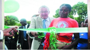• VICE-President Guy Scott is joined by an expectant mother, Patricia Nyangulu in cutting a ribbon during the official hand over of a mothers’ and relatives’ shelter at Chipata General Hospital yesterday. PICTURE BY STEPHEN MUKOBEKO/ZANIS