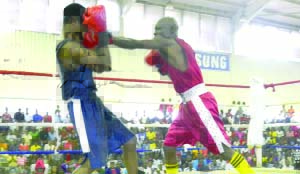  •CHESTER Simpungwe (in red) of Zambia National Service and Bwalya Lumbwe of Mufulira square off during the boxing national trials held at the Olympic Youth Development Centre in Lusaka at the weekend. Picture by CLEVER ZULU 