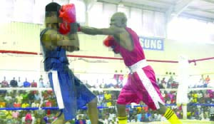 •CHESTER Simpungwe (in red) of Zambia National Service and Bwalya Lumbwe of Mufulira square off during the boxing national trials held at the Olympic Youth Development Centre in Lusaka at the weekend. Picture by CLEVER ZULU