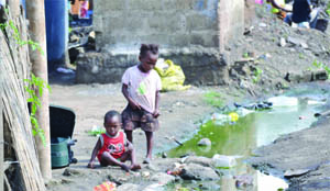 • children play close to dirty stagnant water behind a pit latrine in Lusaka’s Misisi township. Pictures by SAM PHIRI 