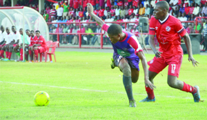 • NKANA midfielder, Kelvin Mubanga (right) battles for the ball with Njabulo Ndlovu of Swaziland’s Mbabane Swallows during the CAF Champions League match at Nkana Stadium in Kitwe yesterday. Nkana beat Swallows 5-2 to qualify to the next round on a 5-4 aggregate score.  Picture by WILSON CHABINGA 