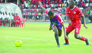 • NKANA midfielder, Kelvin Mubanga (right) battles for the ball with Njabulo Ndlovu of Swaziland’s Mbabane Swallows during the CAF Champions League match at Nkana Stadium in Kitwe yesterday. Nkana beat Swallows 5-2 to qualify to the next round on a 5-4 aggregate score. Picture by WILSON CHABINGA