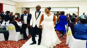 • PRESIDENT Michael Sata’s son, Kazimu walks hand in hand with his wife Tiwonge Mukobeko during their wedding reception in Lusaka last weekend. Picture by STEPHEN KAPAMBWE