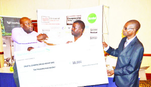 • MAD Max Auto Spares marketing manager Nyambe Maboshe (left) hands over a dummy cheque to Oriental Quarries Boxing Promotion manager, Christopher Malunga as Boxing Board of Control secretary Simon Mwale (right) looks on during the media briefing at Southern Sun hotel in Lusaka yesterday. Picture by CLEVER ZULU.