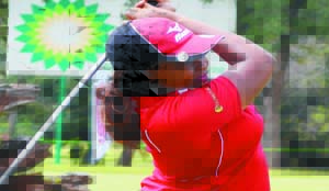 • TOP local amateur, Tina Nawa watches her tee shot on the 10th during the first round of the 2014 Zambia Ladies Golf Open Championship in Ndola yesterday. Picture by FELIX MALUNGA