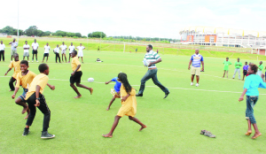 • CONFEDERATION of African Rugby development officer for East and southern Africa, Erick Situma (centre with ball) demonstrates some skills to school children during the launch of the International Rugby Board (IRB) Get Into Rugby project at the Olympic Youth Development Centre in Lusaka at the weekend. Picture by MARTIN MUSUNKA.