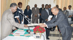 •PRESIDENT Michael Sata receives an affidavit of oath from newly-appointed Supreme Court Judge Justice Albert Wood during a swearing-in ceremony at State House in Lusaka yesterday. Picture by CLEVER ZULU.