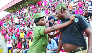 • A Police officer roughs up a suspected Nkana fan during the 2014 CAF Champions League first round, first leg match against Kampala City Council Authority (KCCA) at Arthur Davies Stadium in Kitwe at the weekend. The teams drew 2-2. Picture by JEAN MANDELA