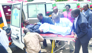 •MUFULIRA District Commissioner Chanda Mfula acts as a mock patient and is pushed on the stretcher into an ambulance by Ndola District Commissioner Rebby Chanda, Copperbelt Minister Mwenya Musenge and Health Deputy Minister Chitalu Chilufya (right). This was when Dr Chilufya handed over ambulances to Copperbelt district-based health institutions yesterday. Picture By JAMES KUNDA