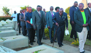 • FOOTBALL Association of Zambia vice-president, Boniface Mwamelo (right) leads First Republican president, Kenneth Kaunda, Labour Minister, Fackson Shamenda, Sports Deputy Minister, Christopher Mulenga and other officials as they file past the tombs of the 1993 Gabon air disaster victims at the Heroes Acre in Lusaka yesterday. Picture by JEAN MANDELA.