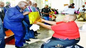 •FIRST Republican President Dr Kenneth Kaunda receives a birthday present at the Cathedral of the Holy Cross in Lusaka during the commemoration of his 90th birthday yesterday. Picture by SAM PHIRI.