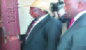•AIRTEL director customer experience Joseph Kafwariman tries door keys to the house, while Airtel “Wina Big” competition winner Wezi Nsabilwa of Lusaka’s Chawama township looks on. This was during a hand over of the 3rd and last house to be won at North Gate Garden recently.Picture by JEAN MANDELA