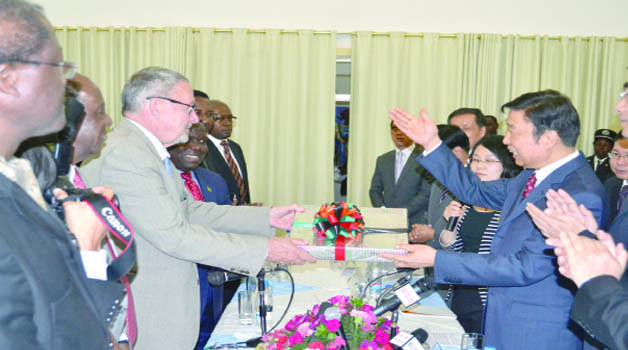 •Vice-President Guy Scott presents a gift to Chinese Vice-President Li Yuanchao (right) at Government House in Lusaka yesterday. Picture by STEPHEN KAPAMBWE.