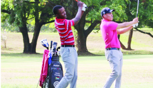 • ZAMBIA’S professional golfer, Michael Chiluba (left) with another player practising on the range at Lusaka Golf Club for the inaugural Zambia Sugar Open Championship this week. Picture by JEAN MANDELA.
