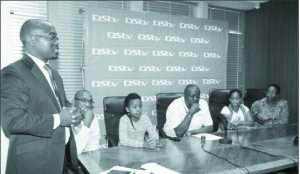 • Acting Multichoice public relations manager Mumbi Mutale gives a congratulatory speech to the Mumba family (flanking him is Multichoice managing director Simon Bota) at Multichoice offices on Tuesday.