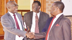 • LAWYER Sakwiba Sikota (left) greets former Zambia Army commander Wisdom Lopa, as former Zambia National Service commandant Anthony Yeta (centre) looks on after they appeared before the magistrate’s court in Lusaka yesterday. Picture by CLEVER ZULU