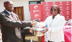 • Airtel Chief executive officer Charity Lumpa (right) hands over a pot to UTH executive director Lackson Kasonka. This was when Airtel employees donated assorted items to the UTH mother’s shelter in Lusaka yesterday. Picture by JEAN MANDELA