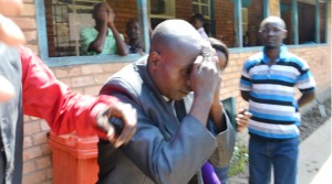 • HOLY Fire Christian Ministry Church Bishop Dominic Nyondo shielding his face from cameras at the Kitwe magistrate’s court after he appeared for defilement yesterday. Picture by MOFFAT CHAZINGWA.