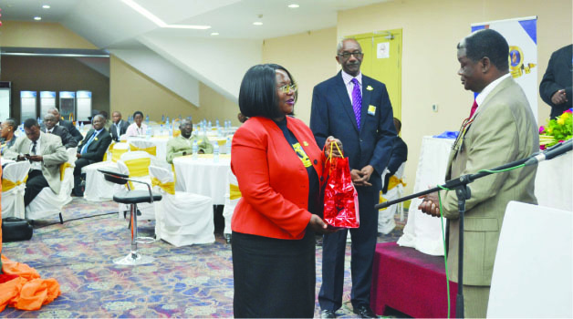 • BANK of Zambia Deputy Governor, Administration Tukiya Kankasa-Mabula (left) presents Copperbelt Permanent Secretary Howard Sikwela with a a gift during the bank’s Northern Region 50th Anniversary business symposium at Levy Mwanawasa Stadium pavillion in Ndola yesterday. Looking on is assistant director, public relations Kanguya Mayondi. Picture by REBECCA MUSHOTA