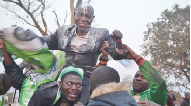 • PF Supporters hoist Lyambai Lingweshi at Mangango Parish Hall after he was declared the winner of Tuesday’s Mangango parliamentary by-elections in Kaoma District. Picture by Sylvester Mwale
