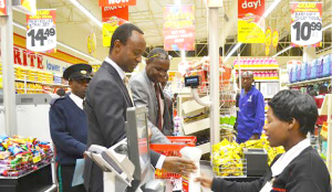 • LUSAKA Mayor Mulenga Sata (left) being attended to by Shoprite front end controller Brandina Namonje (right) as Shoprite general manager Charles Bota (in grey jacket) unpacks the items Mr Sata bought. This was at the newly-opened Shoprite branch at Twin Palm Shopping Mall in Lusaka, which Mr Sata officially opened yesterday. Picture by CHUSA SICHONE.