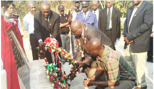 •MINES Deputy Minster Richard Musukwa (left squatting) during the unveiling of the refurbished Kafironda Memorial Monument in Mufulira on Tuesday. Picture courtesy of AEL mining services