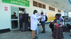 A HEALTH official gets information from a passenger who had just disembarked an international flight at the Simon Mwansa Kapwepwe International Airport in Ndola yesterday. The process is part of screening for Ebola at entry points into Zambia. Picture by REBECCA MUSHOTA