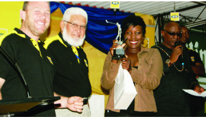 • KAELA Mulenga poses with her trophy after winning the ladies category of the MTN Zambia Golf Challenge Tournament held at the Lusaka Golf Club. Looking on is MTN Zambia head of Business Enterprise Unit (EBU) Mark Townsend (left) and Lusaka Golf Club vice-captain Yusuf Patel (Middle). Picture courtesy of MTN Zambia.