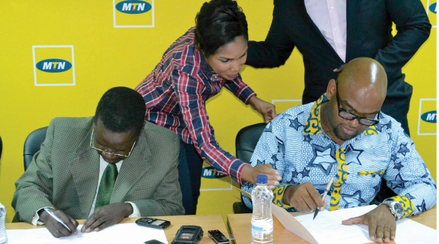 •TIMESPRINTPAK Acting Deputy Managing Director Venarcious Mwansa sings an agreement with MTN Zambia chief sales and distribution officer Amon Jere in Lusaka yesterday. Picture by STEPHEN KAPAMBWE.