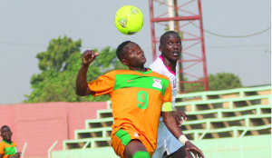 • ZAMBIA captain Paston Daka (left) battles for the ball with Ugandan defender Samuel Nemeyimana during yesterday’s Niger 2015 Africa Junior Championship final round first leg qualifier at Nkoloma Stadium. Zambia won 2-0. Picture by JEAN MANDELA.