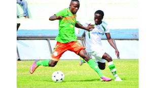 • ZESCO United’s Cletus Chama shields the ball from ‘Mighty’ Mufulira Wanderers defender Taonga Bwembya during yesterday’s Barclays Cup quarter-final clash at Nkoloma Stadium in Lusaka. Zesco won 2 - 0. Picture by CLEVER ZULU.