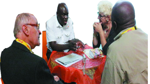 • ZTB senior marketing manager Solistor Cheelo (second left) and ZTB marketing director Mwabashike Nkulukusa (right) interact with Italy’s Sunny Travel proprietor Michelina Gabrie Sanquest (second right) and Italian journalist Bruno Benelli during the 2014 Sanganai/Hlanganani World Travel and Tourism Africa Fair in Harare yesterday. Picture by BRIAN HATYOKA