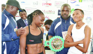 • ZAMBIA’S boxing heroine, Catherine Phiri (second left) poses with her South African opponent Bukiwe Nonina (right) during a weigh in session at Southern Sun hotel in Lusaka yesterday. Picture by CLEVER ZULU