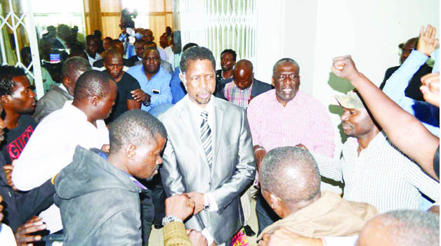 •PF Secretary General Edgar Lungu surrounded by party members as he leaves Government Complex yesterday after a Central Committee meeting.