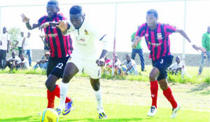 • POWER Dynamos forward Alex Ng’onga tries to beat Zanaco players Augustine Mulenga (left) and Ziyo Tembo (right) during their MTN/FAZ Super League played at Sunset stadium in Lusaka yesterday. Picture by CLEVER ZULU