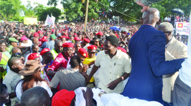 • UNITED Party for National Development president Hakainde Hichilema (smiling in the middle) being mobbed by supporters when he arrived for a rally at the Freedom Park in Kitwe yesterday. Picture by MOFFAT CHAZINGWA