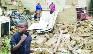• A BOY stands near what used to be his home in Mazabuka which collapsed due to heavy rains on Wednesday.  Picture by EUGENE MUNYAMA