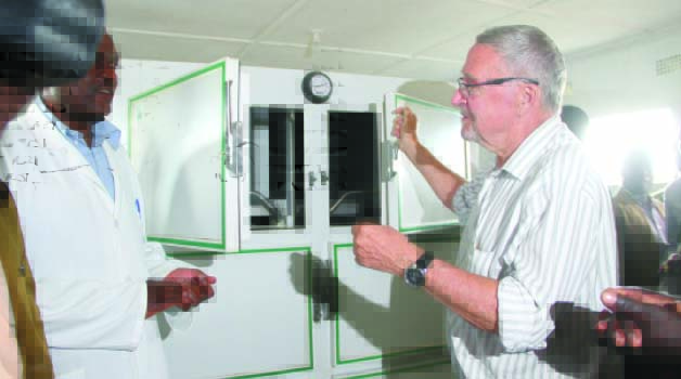 • Acting President Guy Scott talks to Masansa Health Centre officer-in-charge Lackson Chisenga (left) during the commissioning of the first ever mortuary in Old Mkushi yesterday. Picture by THOMAS NSAMA