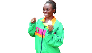 • ZAMBIA’S 200 metres runner, Abigail Sepiso displays the silver medal she won at the African Union Sports Commission Region Five Youth Games in Zimbabwe where she timed 25.16 seconds. Picture by SHAMAOMA MUSONDA
