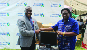 • Mr Okai and Professor Mundia during the presentation of 10 computers donated by Standard Chartered Bank to Copperstone University. Picture by MARTIN MUSUNKA