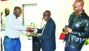 • PARAMOUNT Chief Chitimukulu designate, Henry Kanyanta Sosala of the Bemba people hands over the Tribal Cousins Golf trophy to Ngoni chairperson, Charles Mwanza (left) as his Bemba rival, Kangwa Mukwikile (right) looks on at Ndola Golf Club on Thursday evening. Picture by FELIX MALUNGA