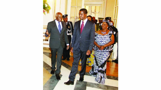 •PRESIDENT Edgar Lungu (centre) and First Lady Esther (right) being welcomed by his Angolan counterpart, Jose Eduardo Dos Santos (left) at the Presidential Palace in Luanda, Angola yesterday. Picture by SALIM HENRY/STATE HOUSE