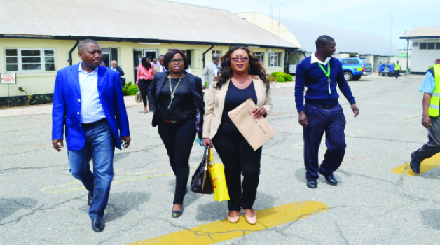 • NIGERIAN business executive Aliko Dangote (left) heads to his private jet (not in picture) for departure from Simon Mwansa Kapwepwe International Airport in Ndola yesterday. This was after he toured his cement plant in Masaiti District. Picture By JAMES KUNDA.