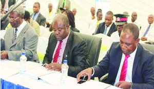 • SPORTS Deputy Minister Ronald Chitotela (centre), FAZ president Kalusha Bwalya (right) and Sports Council of Zambia (SCZ) chairperson Mwamba Kalenga going through the agenda during the FAZ annual general meeting at Mulungushi Rock of Authority in Kabwe yesterday. Picture by MOSES CHIMFWEMBE