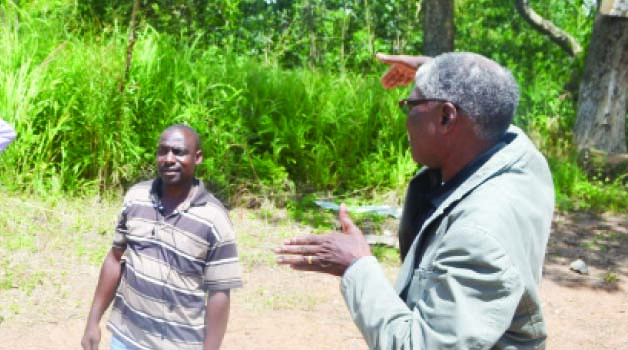 • NDOLA District Commissioner (DC) Rebby Chanda (right) shows Sunday Times staffers (not in picture) the land that will be de-gazetted for allocation to residents at Ndola Forest, while estate agent Felix Zimba looks on. Picture by MUNAMBEZA MUWANEI