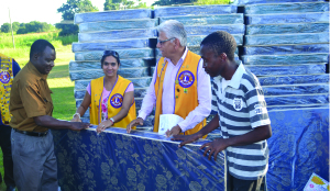 •NDOLA Lions School for the visually impaired acting deputy head teacher Kombe Mulenga (left) receives one of the mattress from Lions Club of Ndola president Tejal Panchal (second from left) and Lions Club International